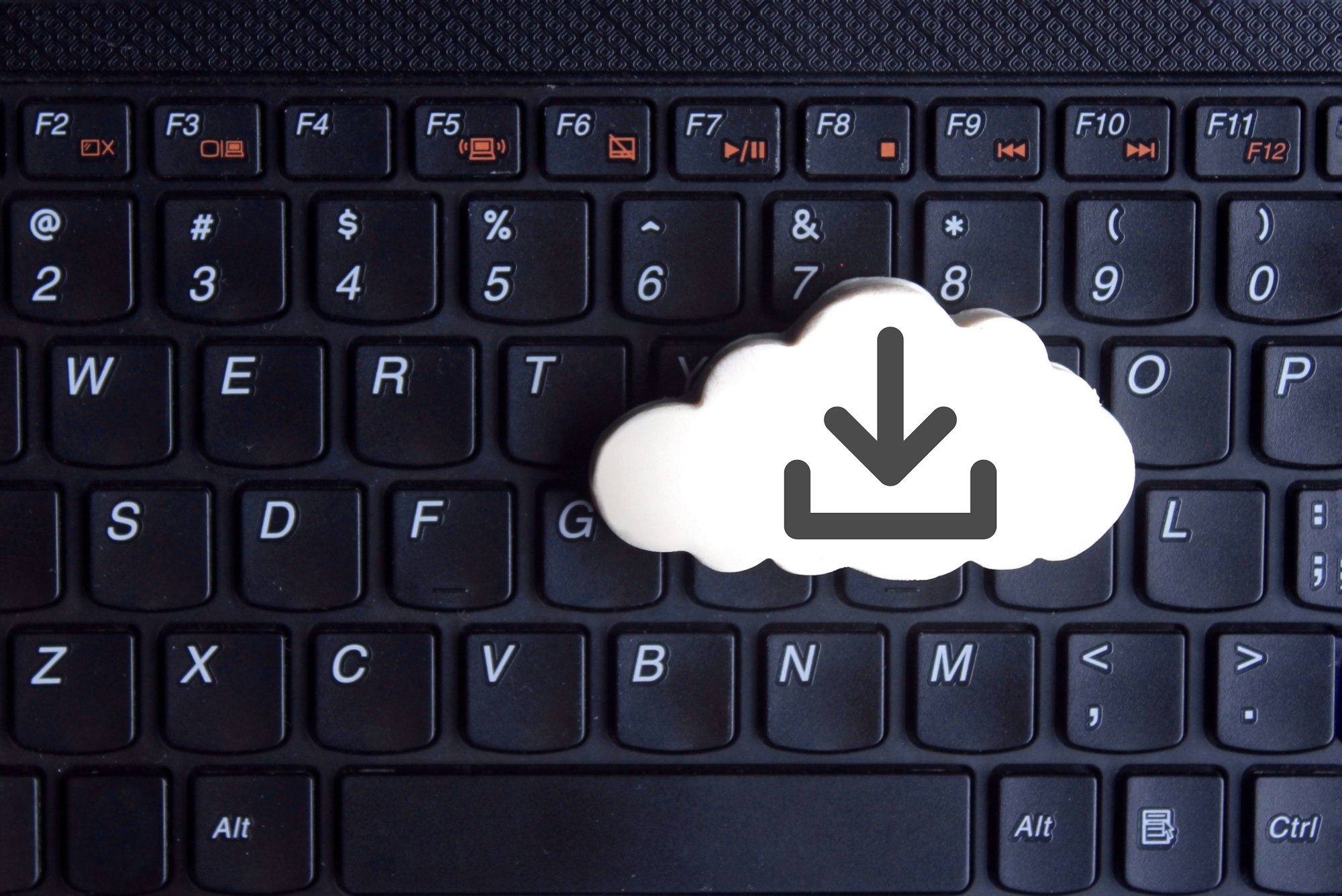 White cloud with download icon on keyboard